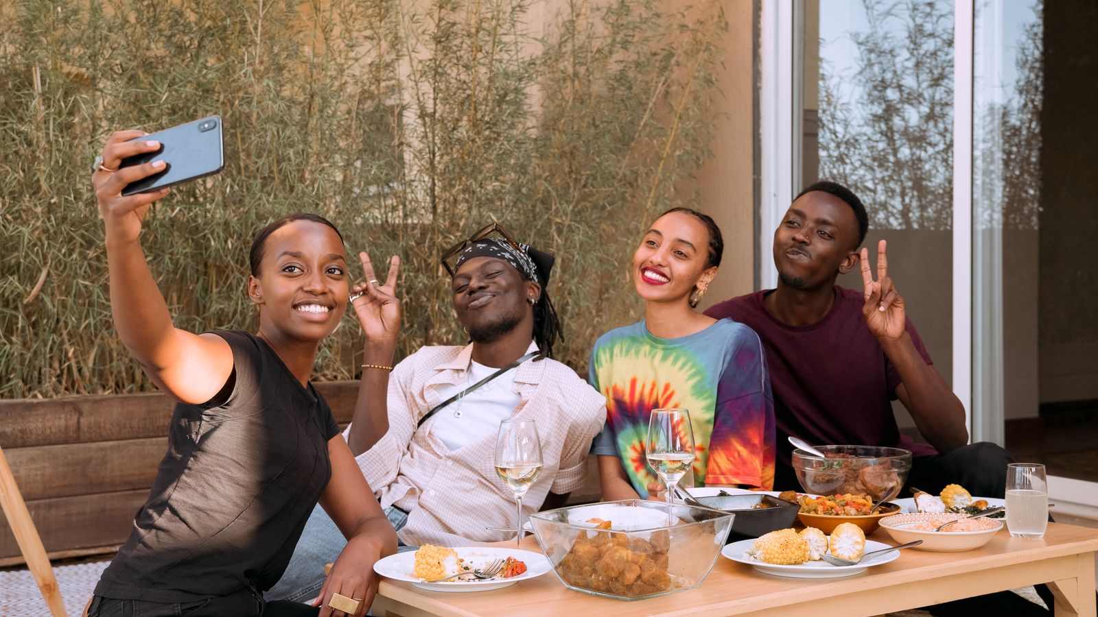 A group of friends taking a photo together at a restaurant table