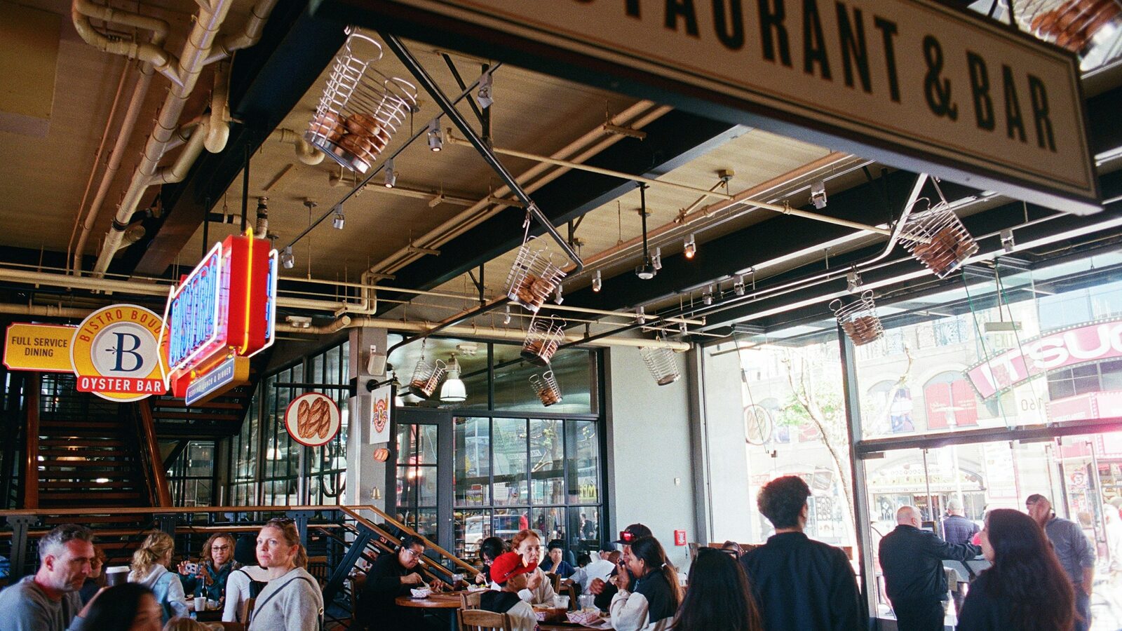 A busy American restaurant and bar dining room full of guests