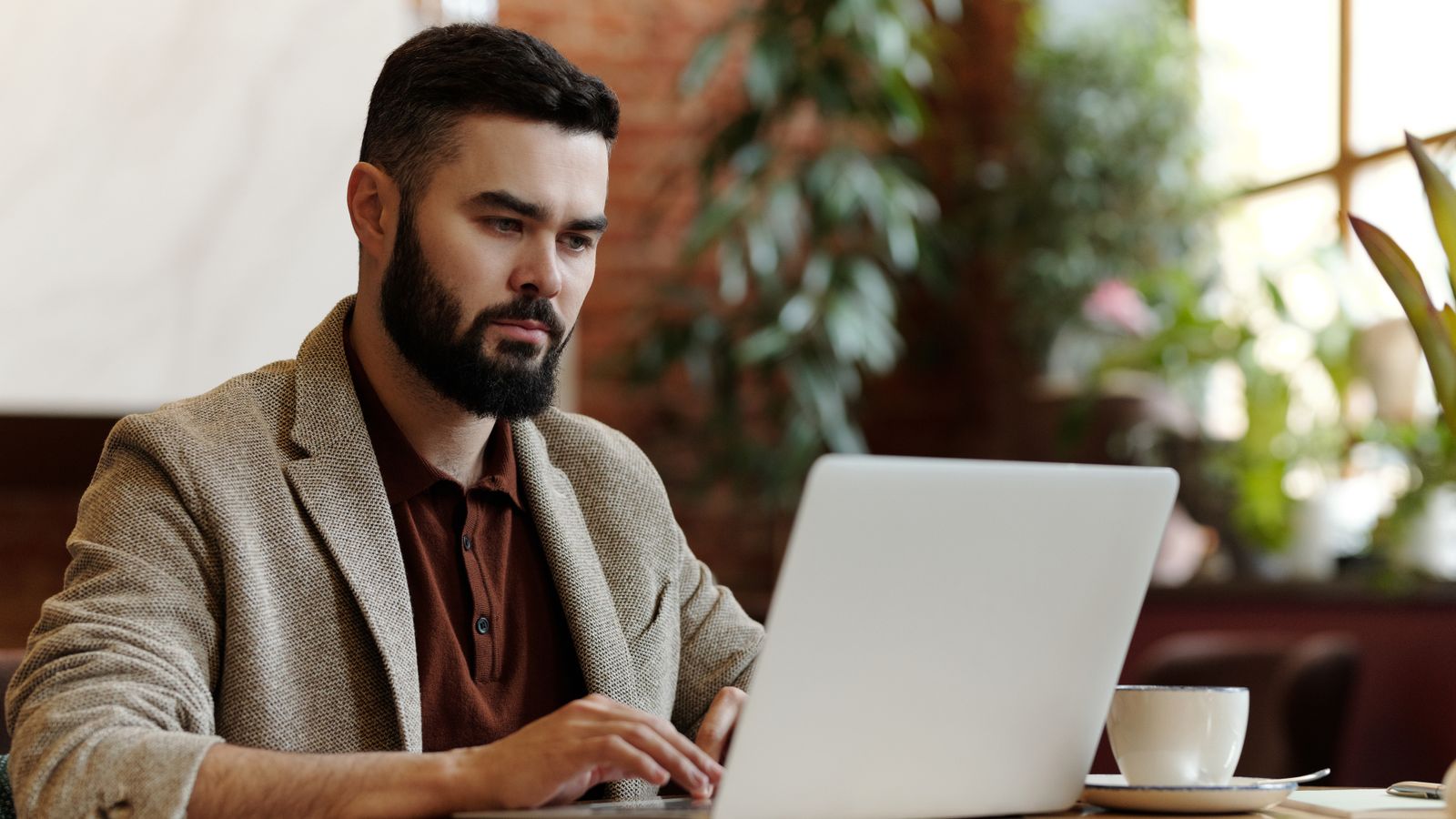 A restaurant website open on a laptop at a cafe table